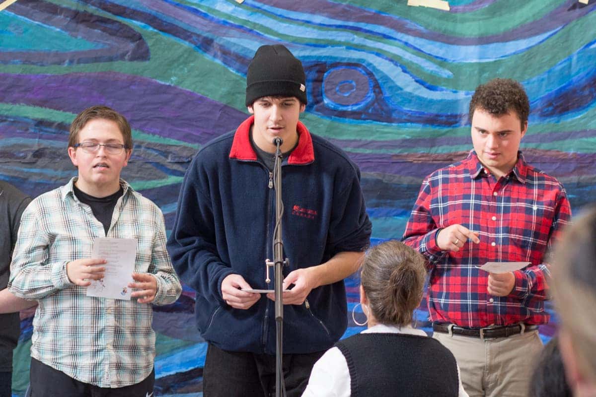 Victory Academy students speaking at a microphone