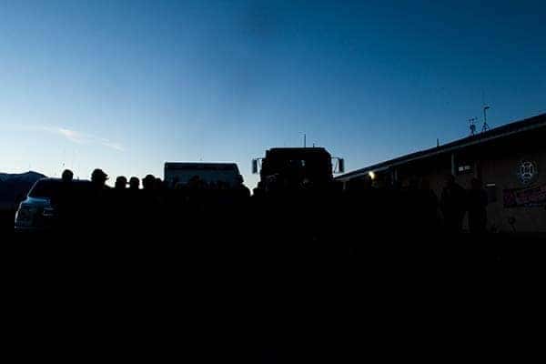 Silhouettes of first responders and emergency vehicles at dusk