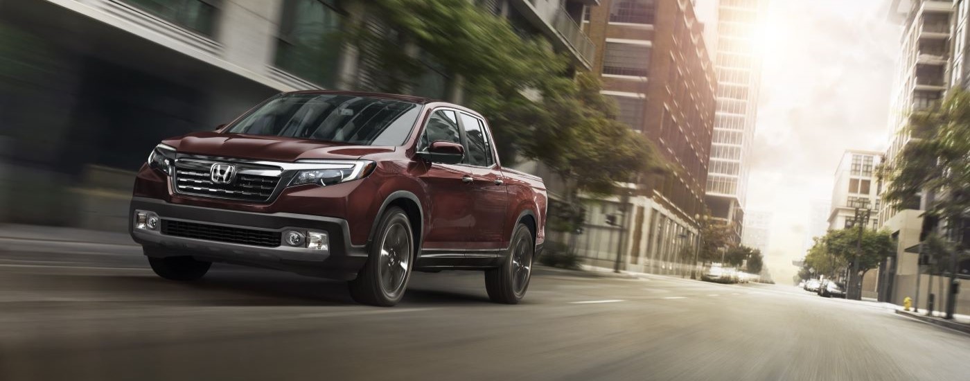Maroon 2017 Honda Ridgeline RTL-E driving on a city street