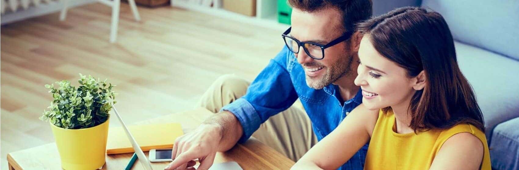 Couple shopping online for a car