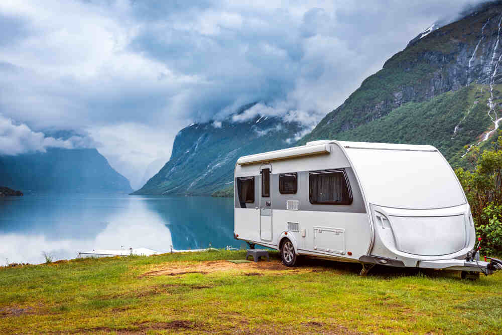 Camper parked overlooking the water.
