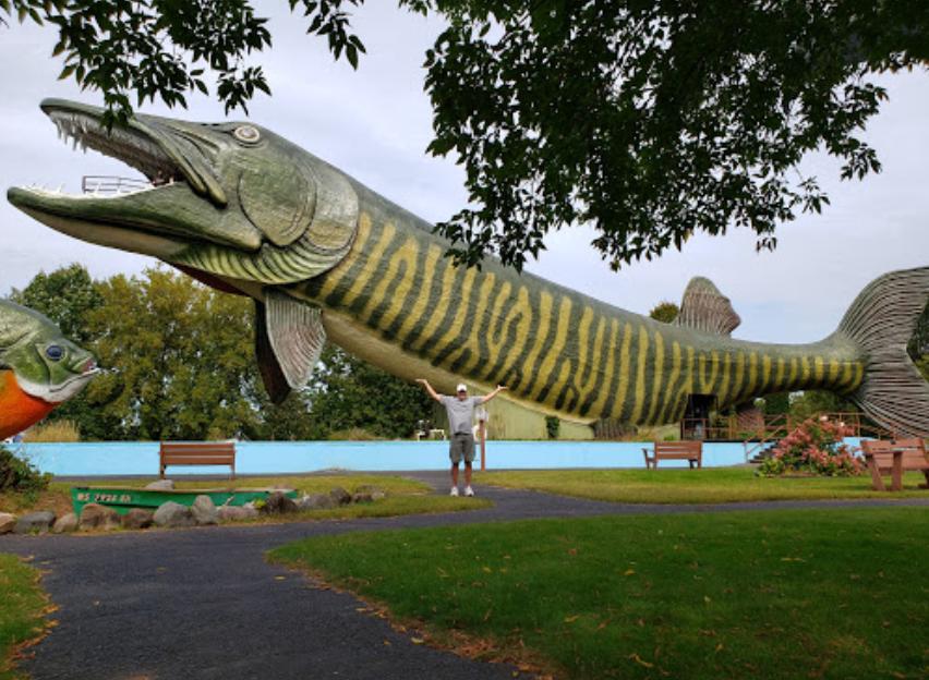 man standing in front of giant musky building