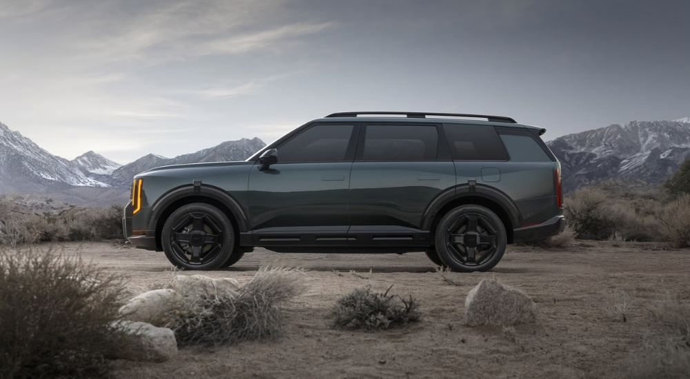 Green 2027 Kia Telluride parked near mountains