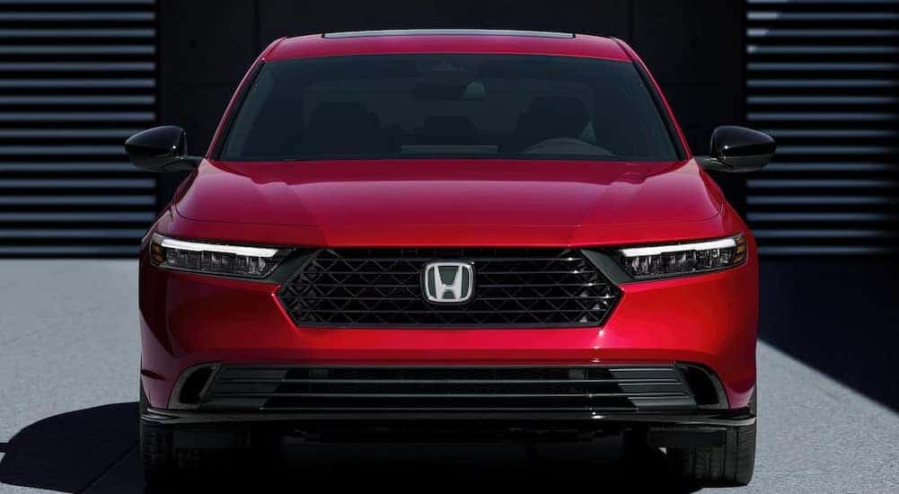 A red 2024 Honda Accord Sport-L Hybrid is shown parked.