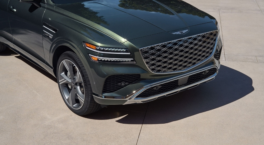 Front grille on a green 2025 Genesis GV80 for sale.