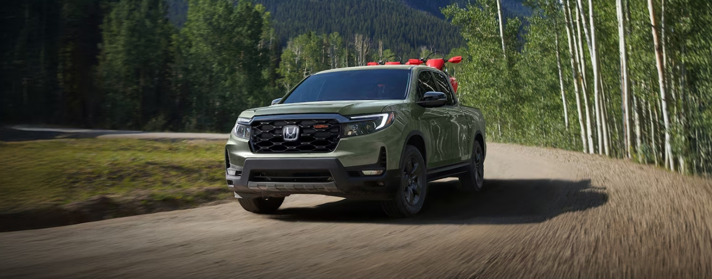 Green 2026 Honda Ridgeline TrailSport driving on a trail