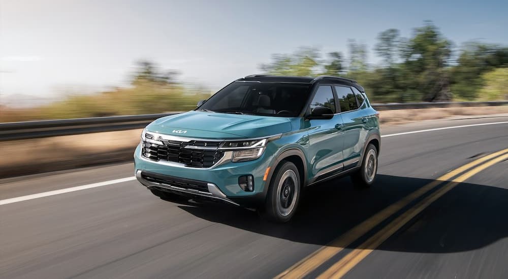 Blue 2025 Kia Seltos driving on a highway