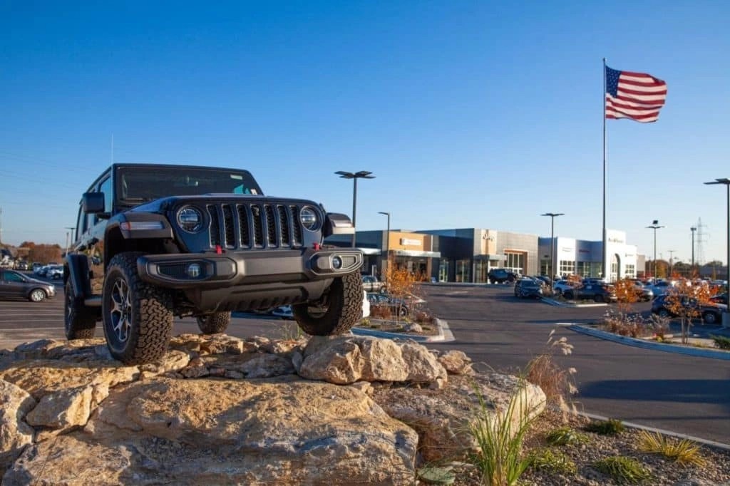 Jeep Wrangler in Front of Jim Glover CDJRF Dealership Lot & Showroom