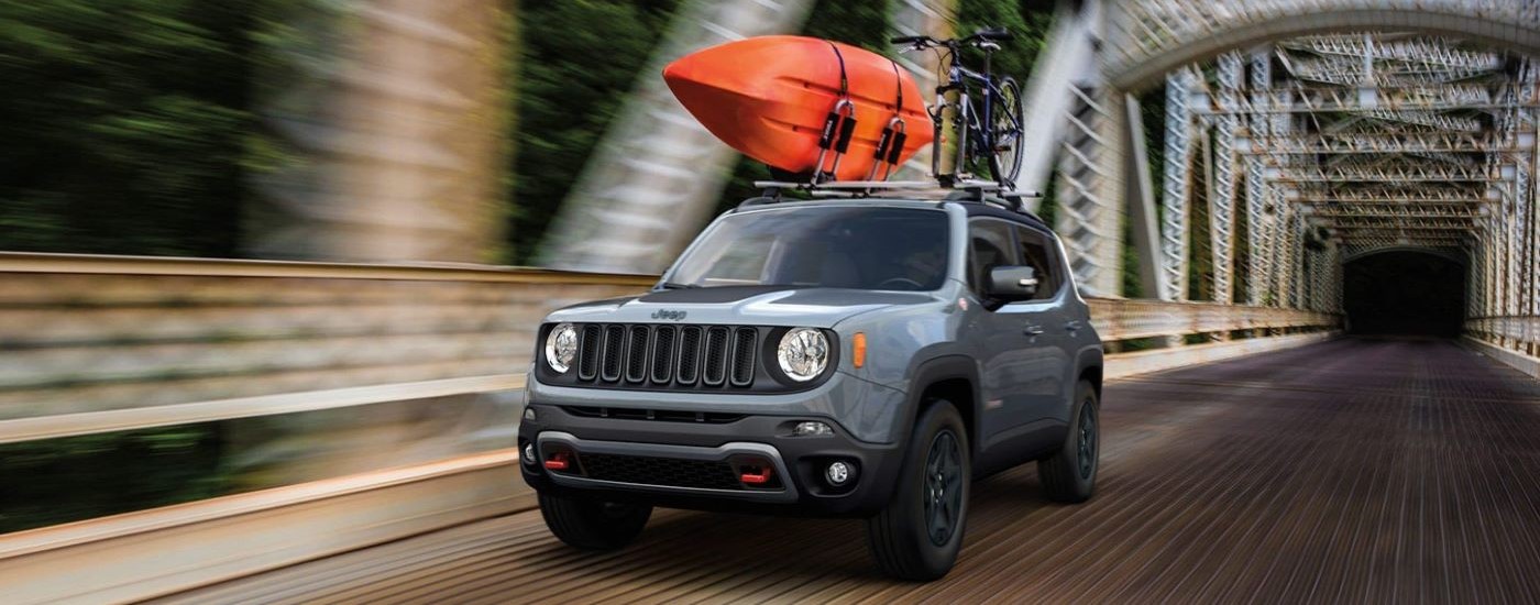 A grey 2020 Jeep Renegade Trailhawk is shown driving over a bridge after leaving a used Jeep dealer.