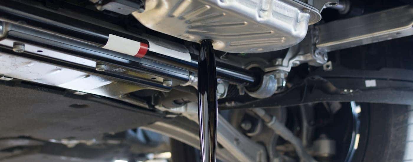 A close up shows oil draining during a Honda maintenance Rochester in NY.