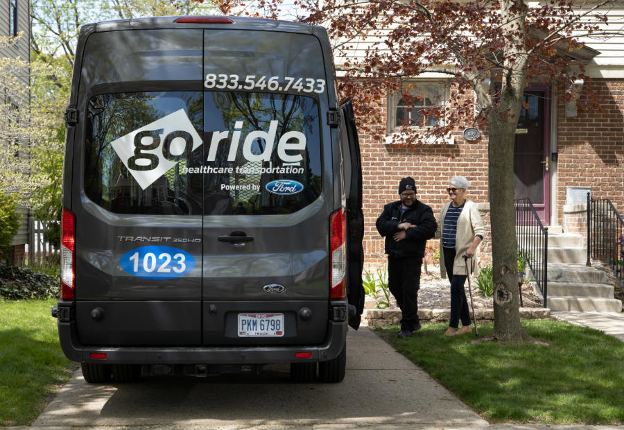 helping an older lady into the Go Ride van