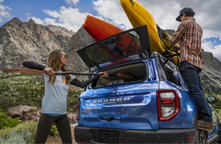 Couple Loading Kayaks in Blue 2023 Ford Bronco Sport