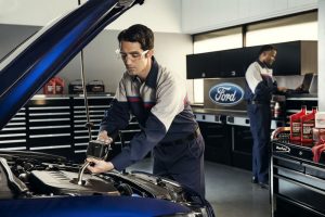 Ford service technicians working on a car