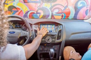 woman using the infotainment system of her 2018 Ford Focus