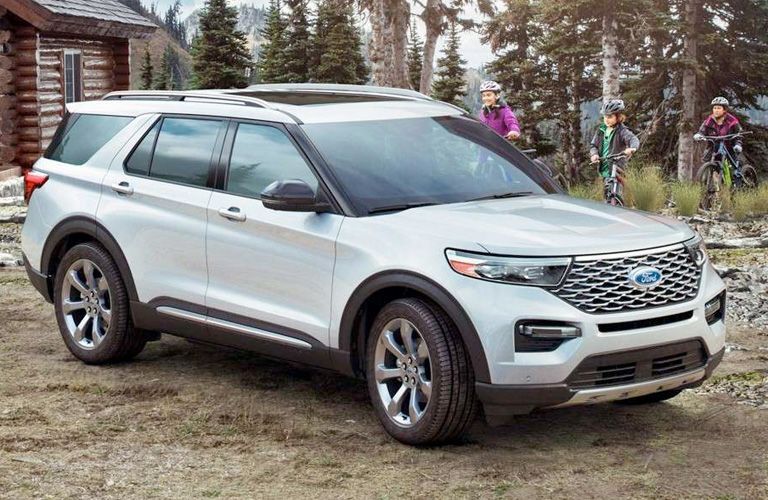 side view of a white 2021 Ford Explorer Hybrid