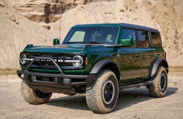 An Eruption Green 2022 Ford Bronco backdropped by an arid cliff