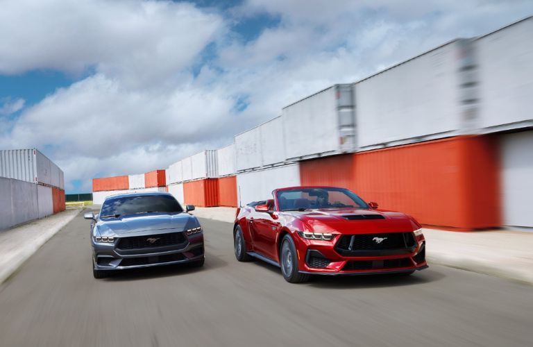 Gray and Red 2024 Ford Mustang Models Racing on a Track