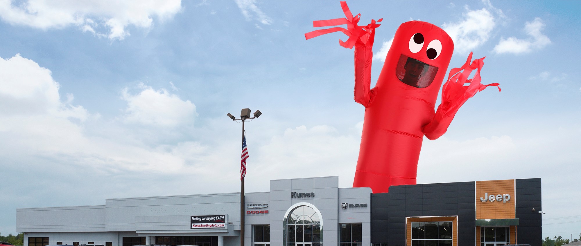 giant red inflatable tube man with googly eyes behind sterling chrysler dodge jeep RAM dealership