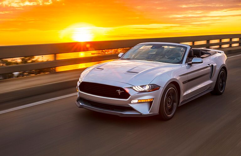 front view of a silver 2019 Ford Mustang California Special convertible with a sunset in the background