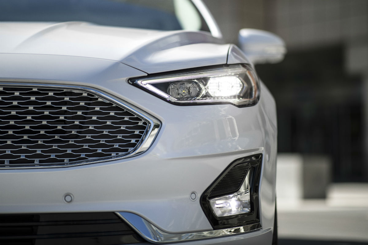 front of a white 2019 Ford Fusion