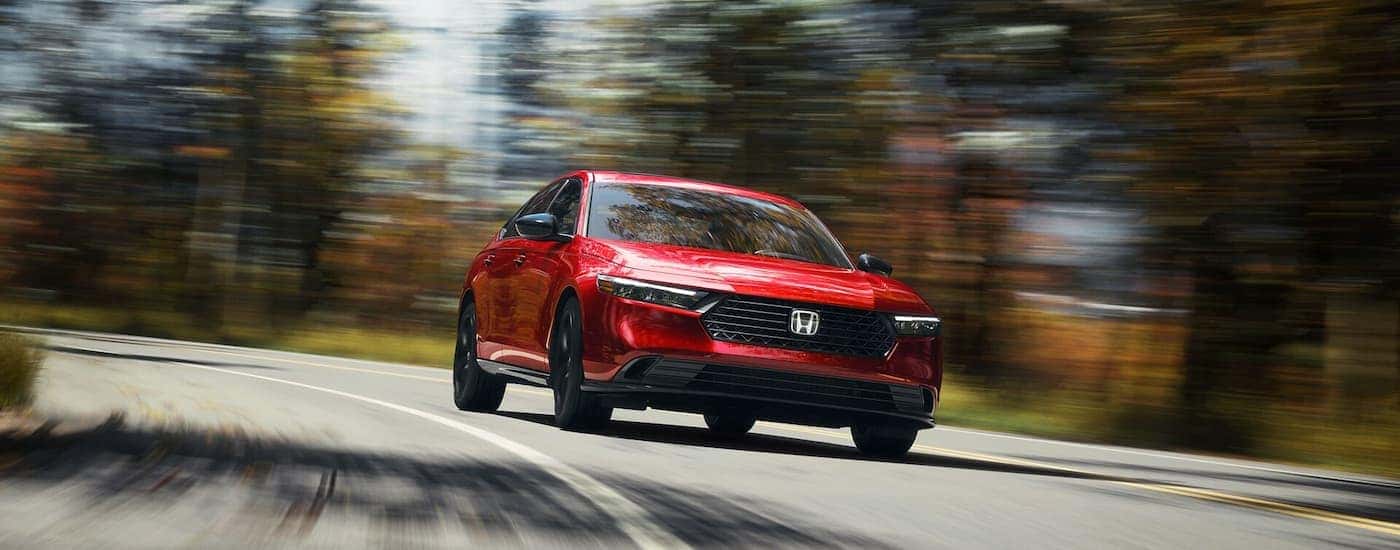 A red 2025 Honda Accord driving down the road.