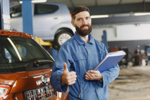 Kirksville, MO mechanic giving a thumbs up in his shop.