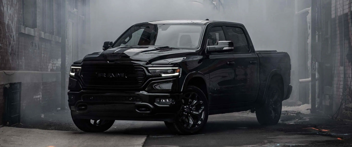 A black ram truck sitting parked.