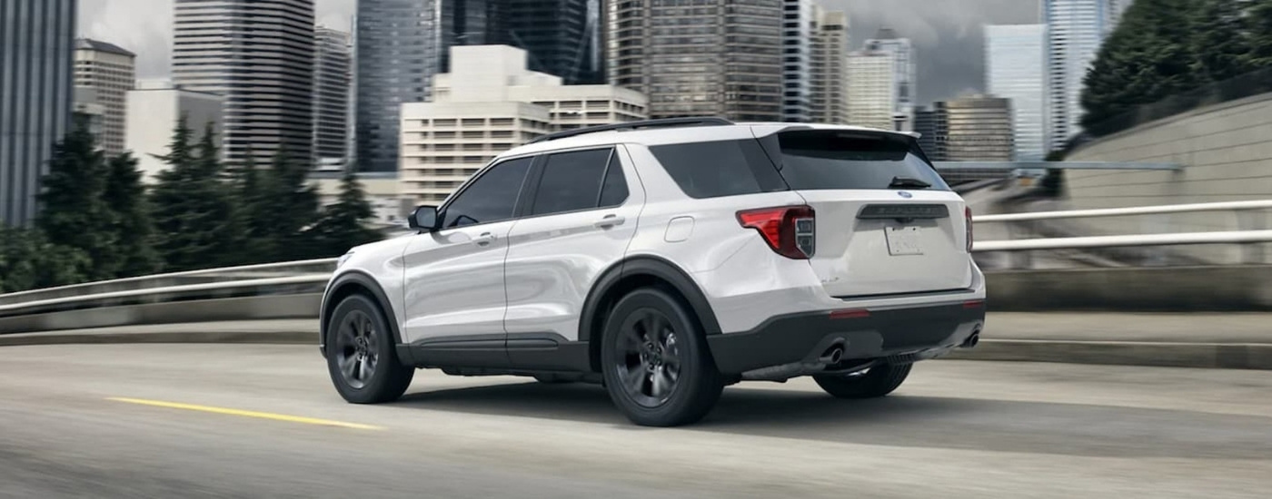 A white 2023 Ford Explorer from the rear at an angle.
