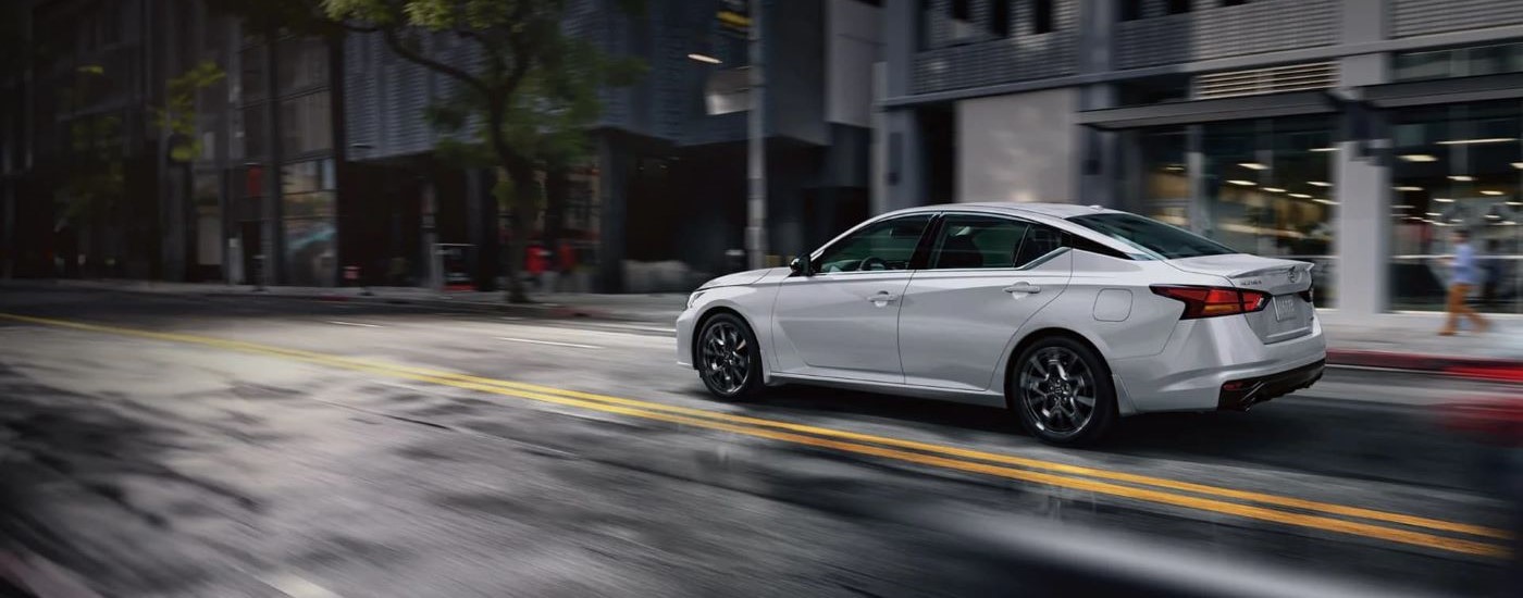 Silver 2025 Nissan Altima driving to a Nissan dealer near Fridley