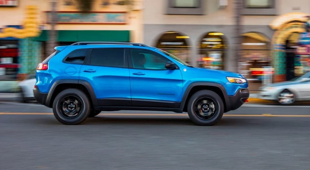 A blue 2020 Jeep Cherokee from the side.