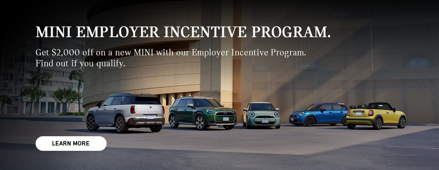 MINI fleet parked in front of a parking structure.