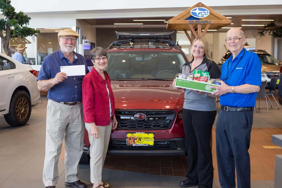 Wilsonville Subaru staff presenting donations to St. Vincent de Paul volunteers