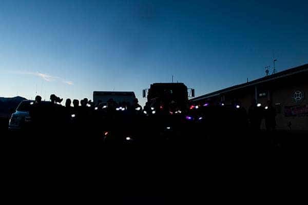 Emergency vehicle lights glowing at dusk