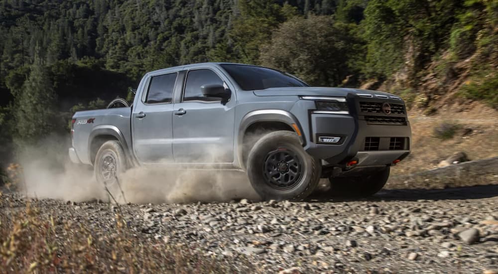 Silver 2026 Nissan Frontier driving off-road.