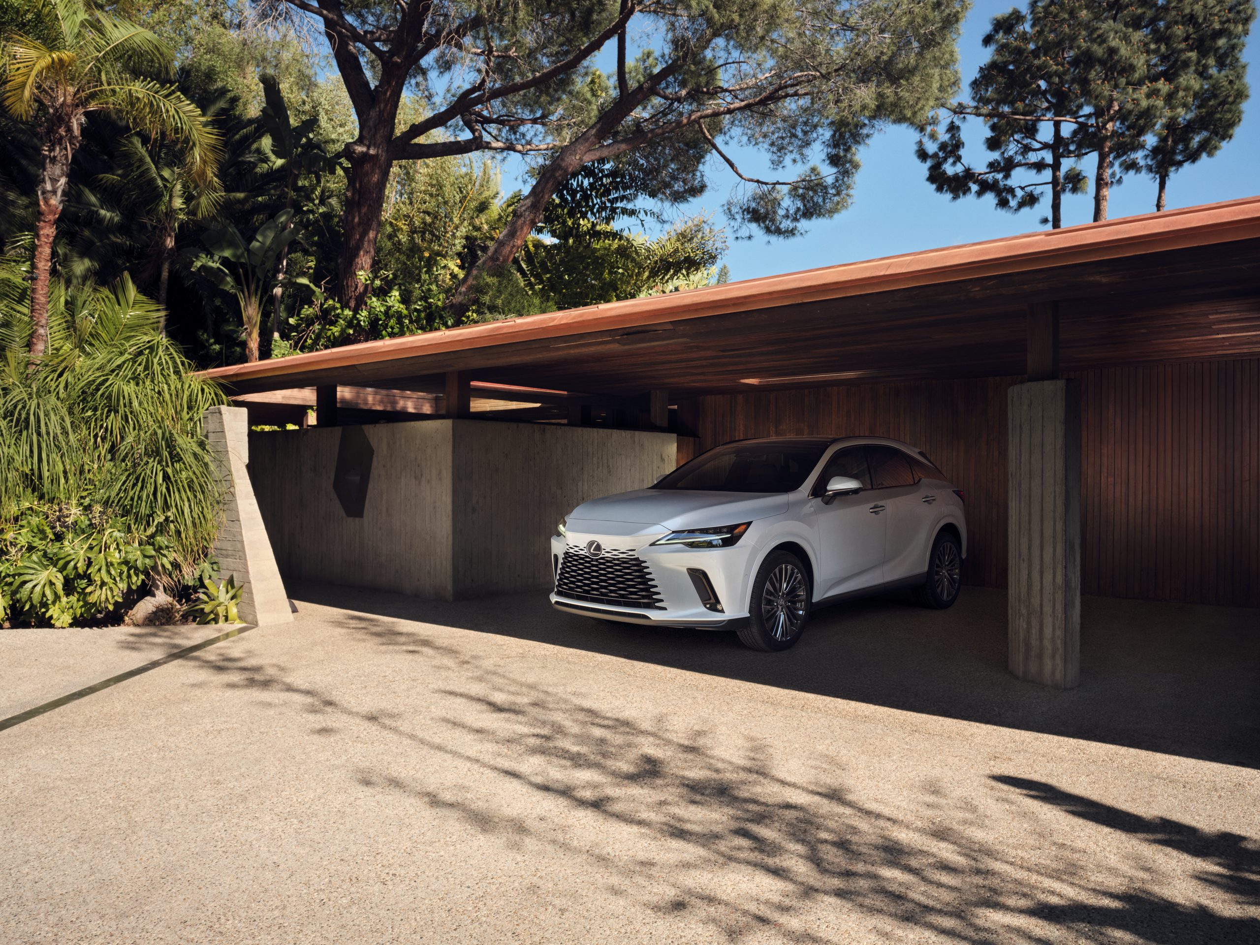 RX 350 Hybrid Luxury all-wheel drive shown in Ultra White underneath a covered parking space. 