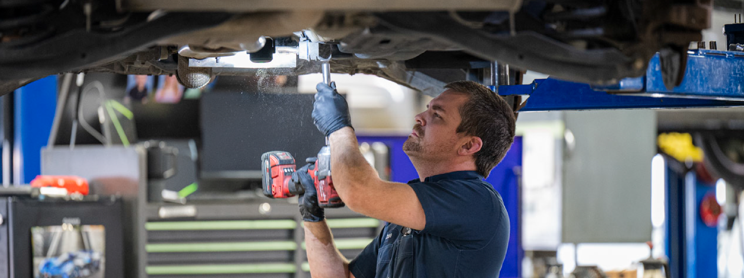 Automotive technician working on a vehicle engine bay