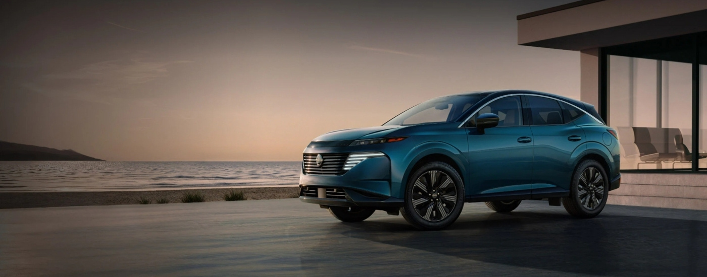 Blue 2025 Nissan Murano for sale parked near a modern house