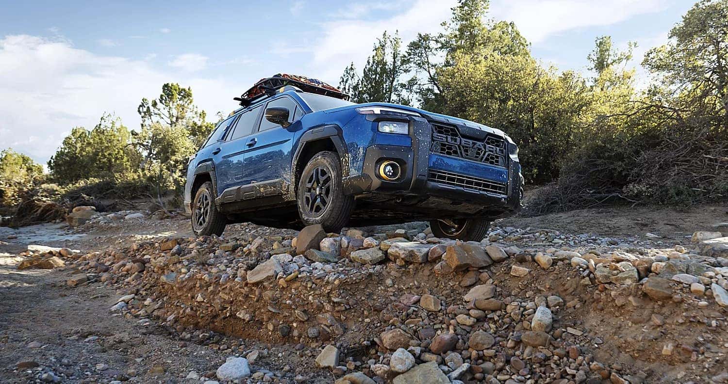 Blue 2026 Subaru Outback climbing a rocky trail