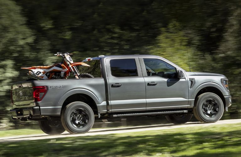 Gray 2024 Ford F-150 with Dirt Bike in the Bed