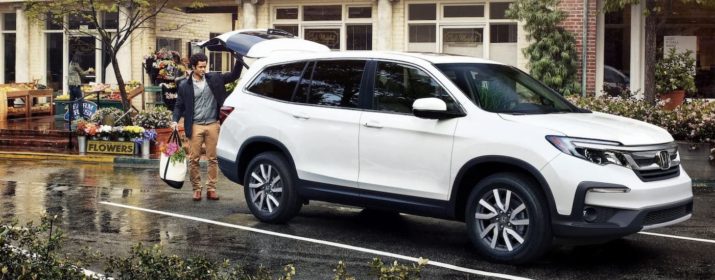 A white 2021 Honda Pilot for sale is shown from the front at an angle.