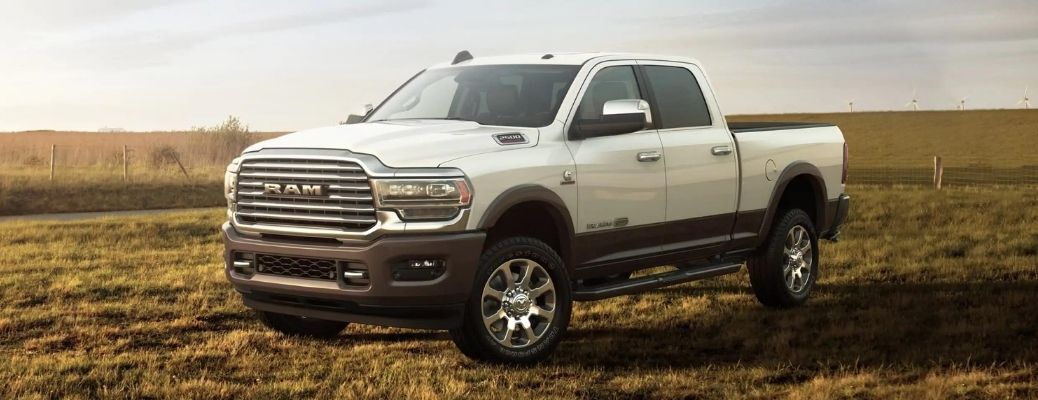 A white  2021 RAM 2500 parked in a field.