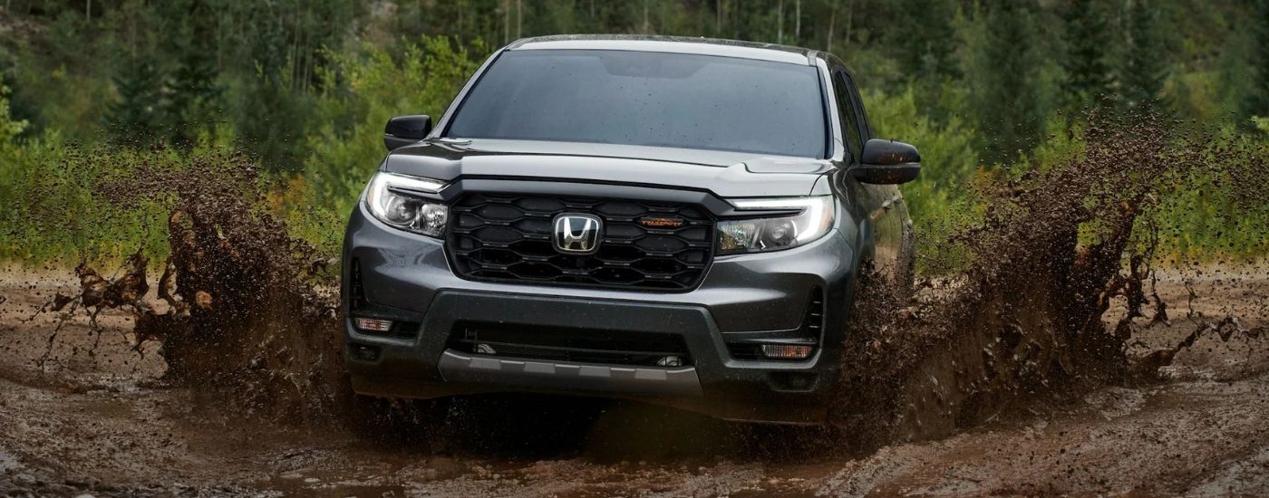 Grey 2026 Honda Ridgeline TrailSport kicking up mud