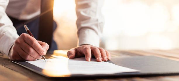 Man signing piece of paper