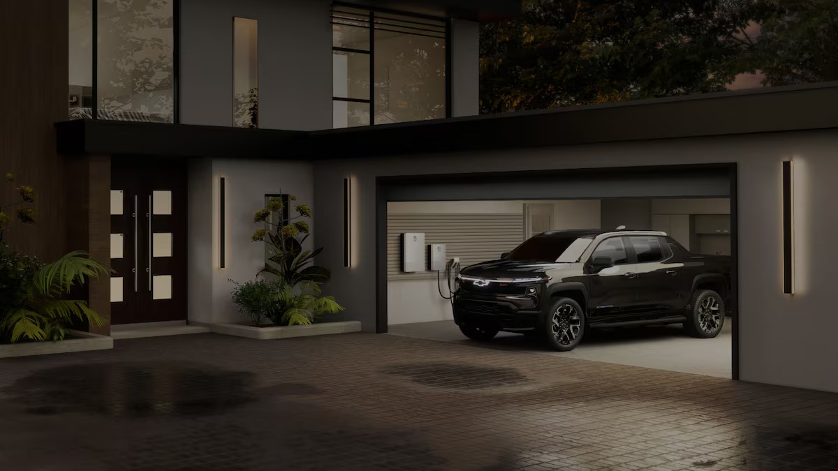 2025 Chevy Silverado EV Exterior Driver Side Front Profile while Charging in Home Garage