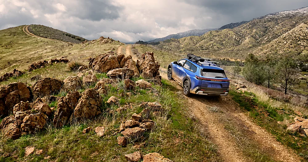 2026 Trailseeker electric vehicle SUV driving in mountainous terrain