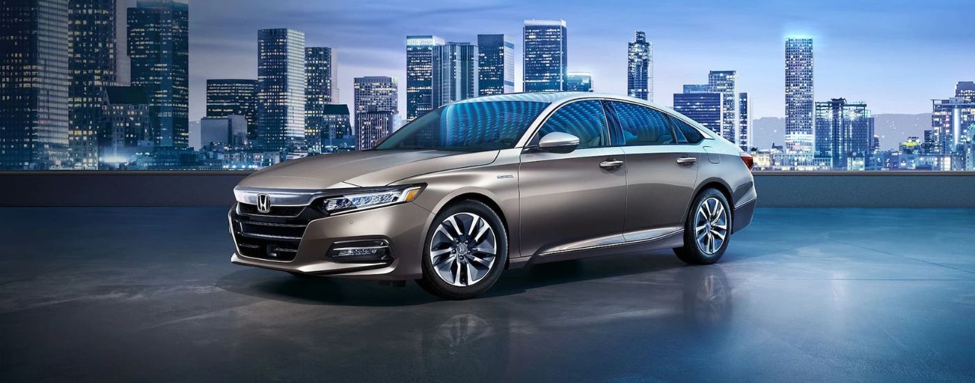 Brown 2018 Honda Accord Hybrid parked in a city.