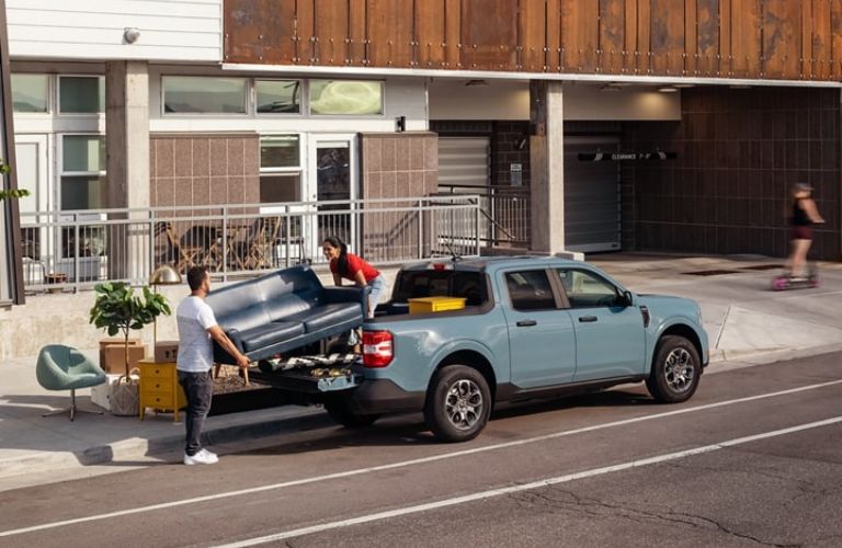 Man and Woman Loading Cargo in Bed of 2023 Ford Maverick