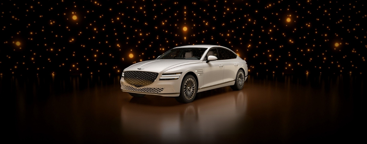 White 2024 Genesis G80 EV parked in a modern gallery