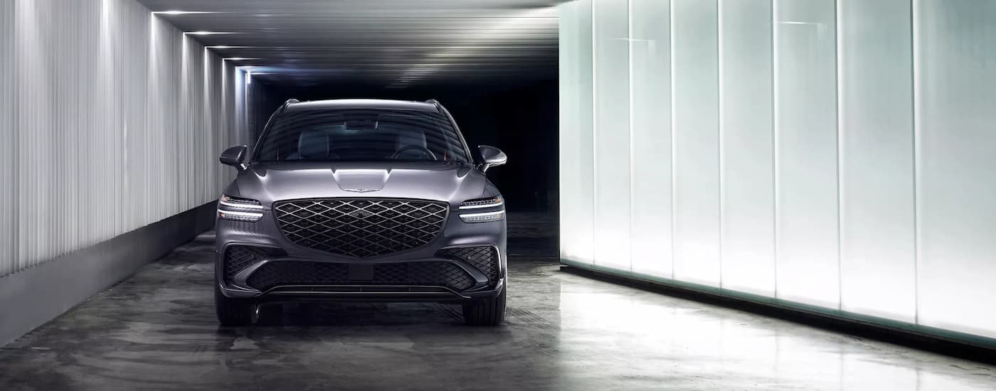 Grey 2026 Genesis GV70 driving in a parking garage
