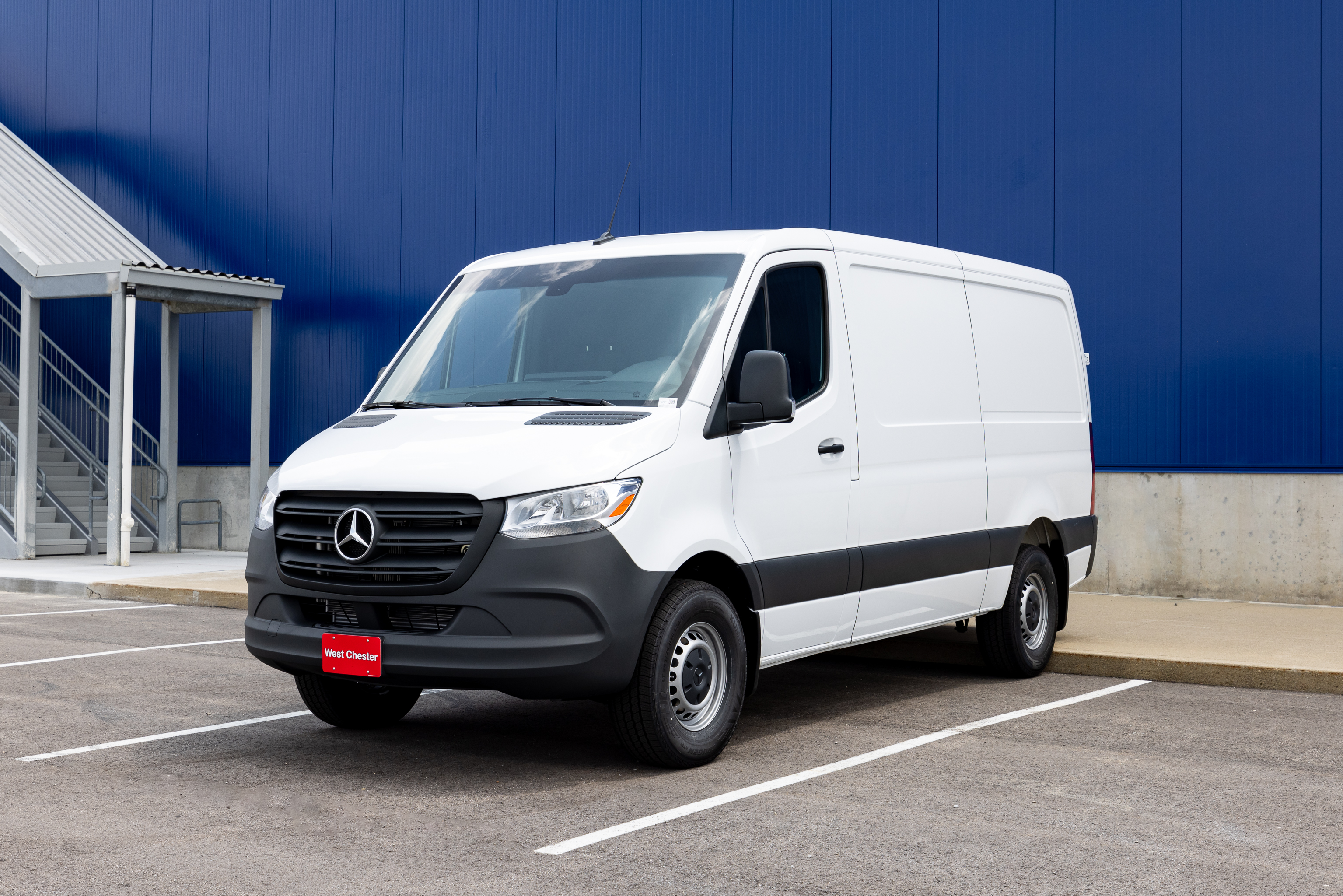 A white Mercedes-Benz Sprinter van in a parking lot